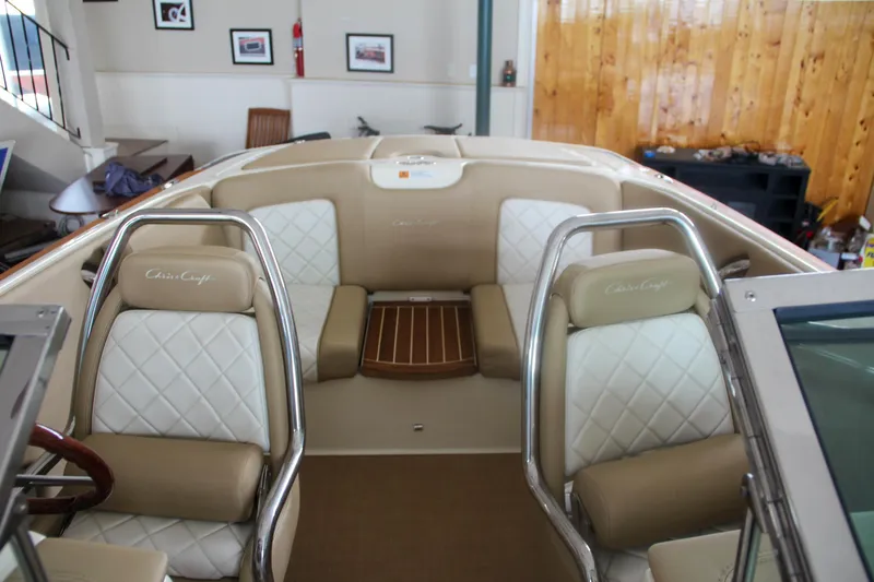Slide: The Image of 2014 Chris-Craft Launch 22 boat interior with beige and white seating. - 26