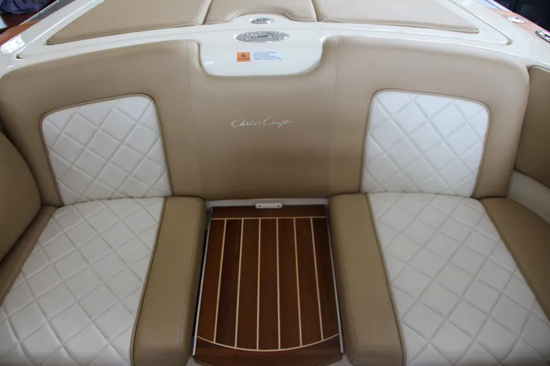 Slide: The Image of 2014 Chris-Craft Launch 22 boat interior with beige and white quilted seats. - 27