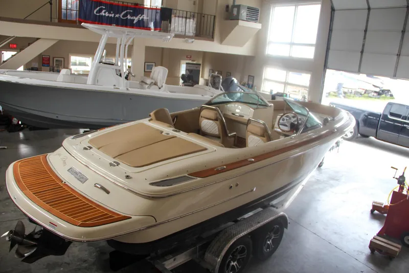 Slide: The Image of 2014 Chris-Craft Launch 22 boat in showroom, beige interior, on trailer. - 3