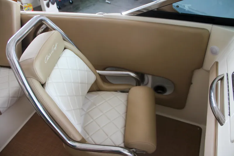 Slide: The Image of Luxurious interior of 2014 Chris-Craft Launch 22 boat with beige and white seating. - 38