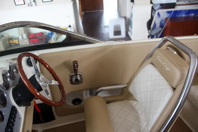 Slide: The Image of 2014 Chris-Craft Launch 22 interior with tan leather seats and wooden steering wheel. - 46