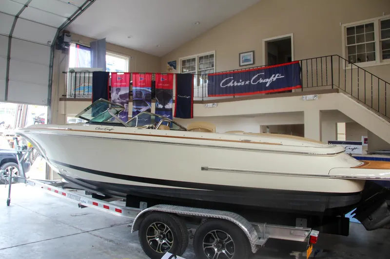 Slide: The Image of 2014 Chris-Craft Launch 22 boat on trailer in showroom. - 8