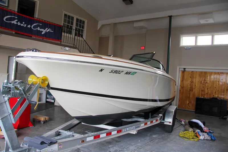 Slide: The Image of 2014 Chris-Craft Launch 22 boat on trailer in indoor storage. - 9