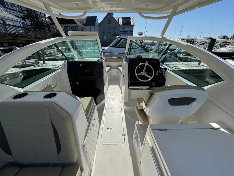 Slide: The Image of 2020 Pursuit DC 266 Dual Console boat interior with helm and seating. - 11