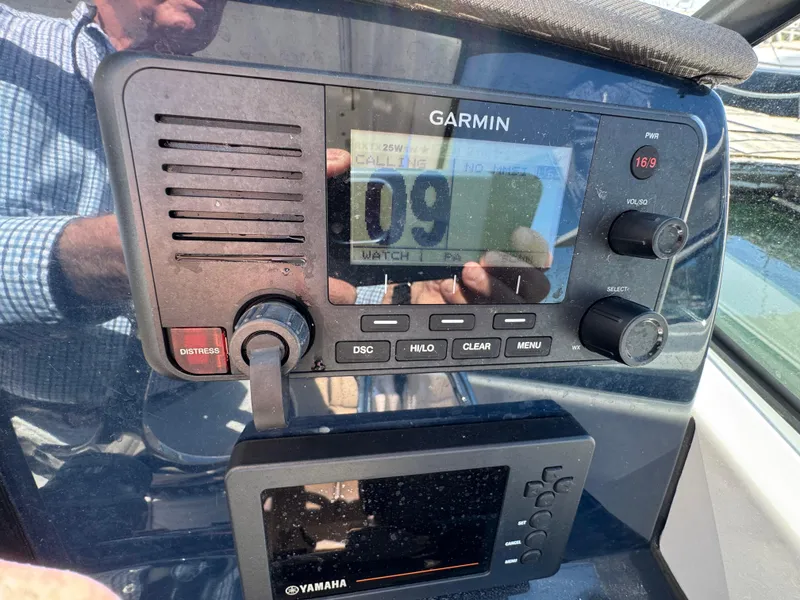 Slide: The Image of Garmin marine radio and Yamaha display on 2020 Pursuit DC 266 Dual Console boat. - 12