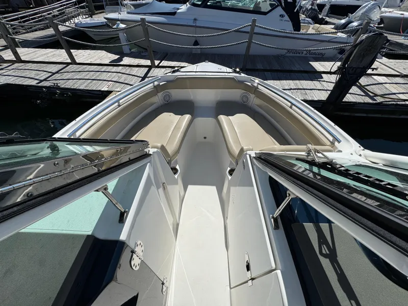 Slide: The Image of 2020 Pursuit DC 266 Dual Console boat with spacious seating at dock. - 14