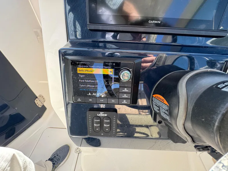 Slide: The Image of Control panel of a 2020 Pursuit DC 266 Dual Console boat with audio system. - 15