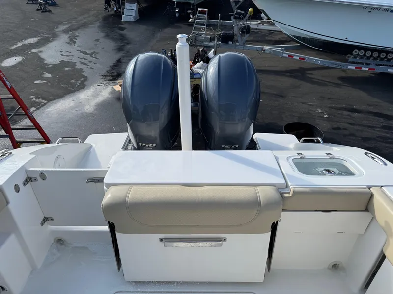 Slide: The Image of 2020 Pursuit DC 266 Dual Console boat with twin engines and seating area. - 19