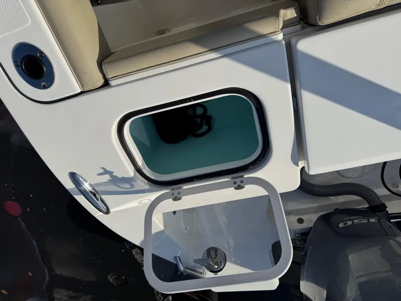 Slide: The Image of 2020 Pursuit DC 266 Dual Console boat with open storage compartment. - 21