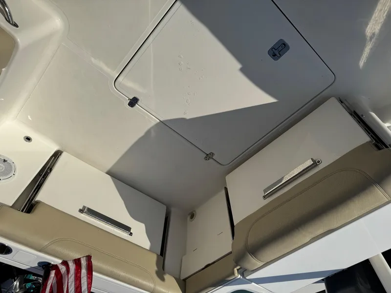 Slide: The Image of Interior view of 2020 Pursuit DC 266 Dual Console boat with storage compartments. - 22