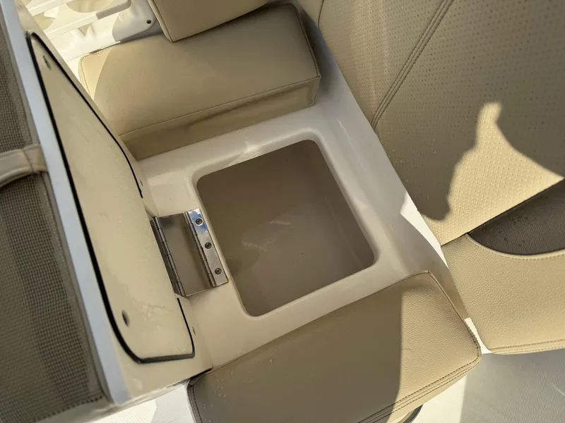 Slide: The Image of 2020 Pursuit DC 266 Dual Console boat seat storage compartment. - 25