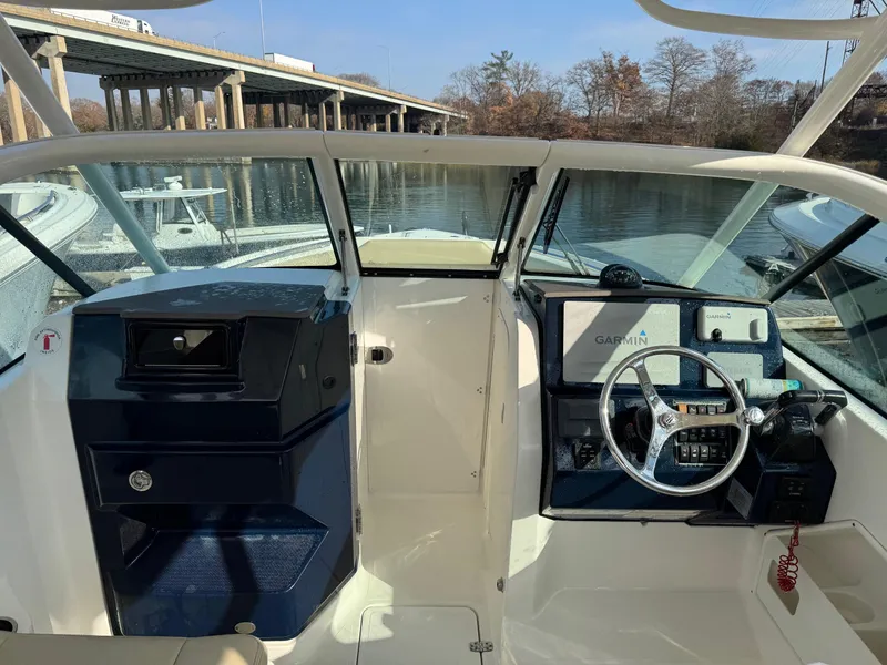 Slide: The Image of 2020 Pursuit DC 266 Dual Console boat interior with steering wheel and navigation system. - 32