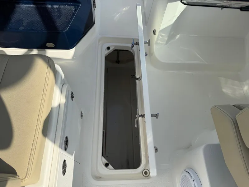 Slide: The Image of 2020 Pursuit DC 266 Dual Console boat interior storage compartment. - 43