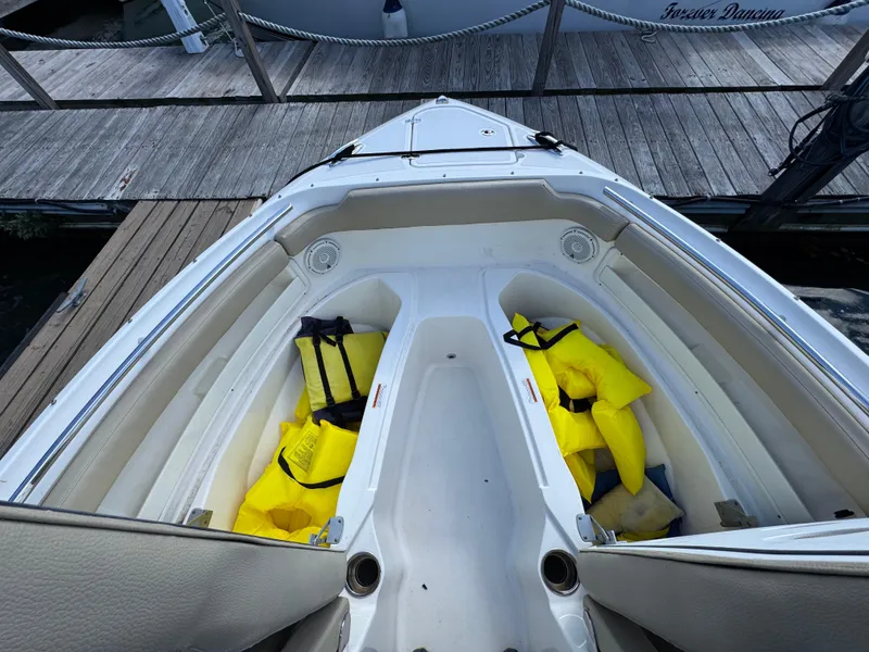 Slide: The Image of 2020 Pursuit DC 266 Dual Console boat with yellow life jackets on deck. - 6