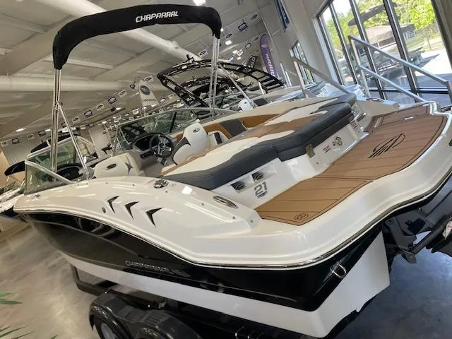 Slide: The Image of 2025 Chaparral 21 SSi boat in showroom, featuring sleek design and modern amenities. - 2