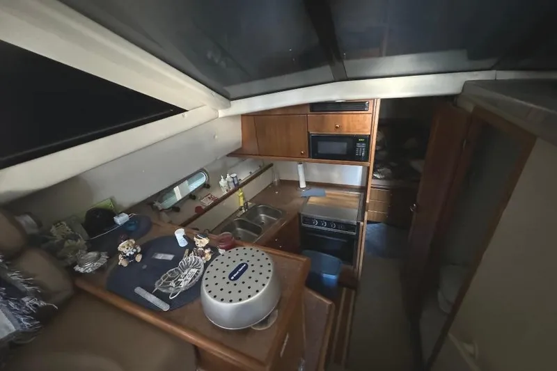 Slide: The Image of Interior of 1999 Bayliner 3388 Command Bridge Motoryacht kitchen area with appliances and storage. - 10