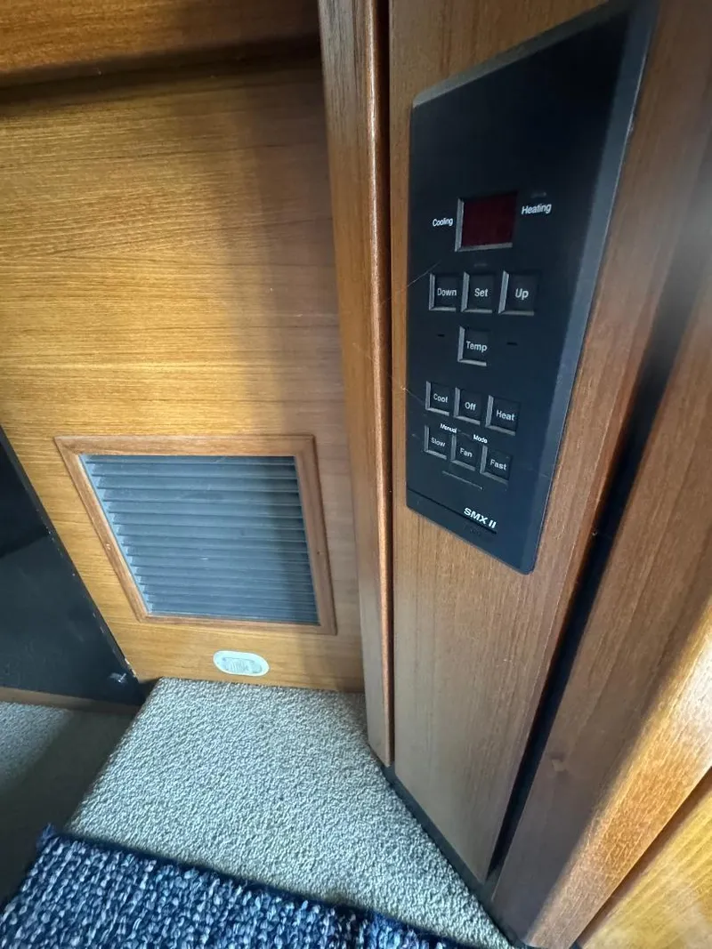 Slide: The Image of 1999 Bayliner 3388 Command Bridge Motoryacht interior control panel and vent. - 12