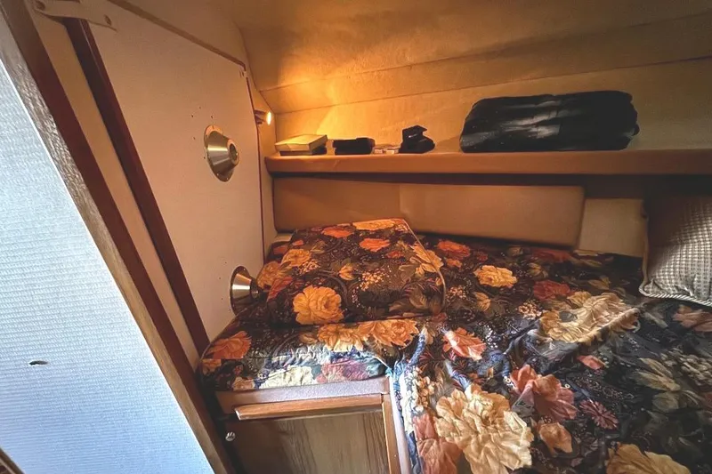 Slide: The Image of Cozy cabin interior of 1999 Bayliner 3388 Command Bridge Motoryacht with floral bedding. - 13