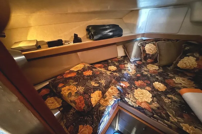 Slide: The Image of 1999 Bayliner 3388 Command Bridge Motoryacht cabin with floral bedding and cozy interior. - 15