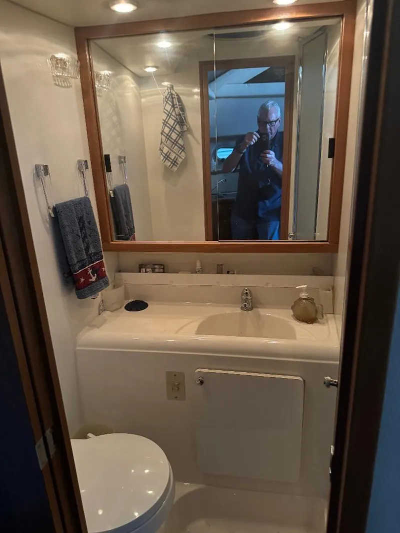 Slide: The Image of Bathroom interior of 1999 Bayliner 3388 Command Bridge Motoryacht, featuring sink and mirror. - 16