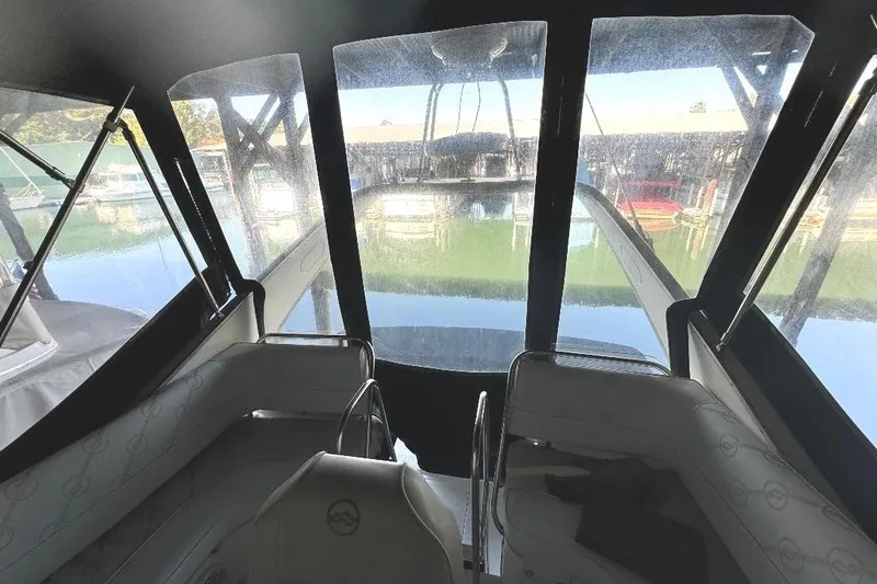 Slide: The Image of 1999 Bayliner 3388 Command Bridge Motoryacht interior view with marina backdrop. - 21