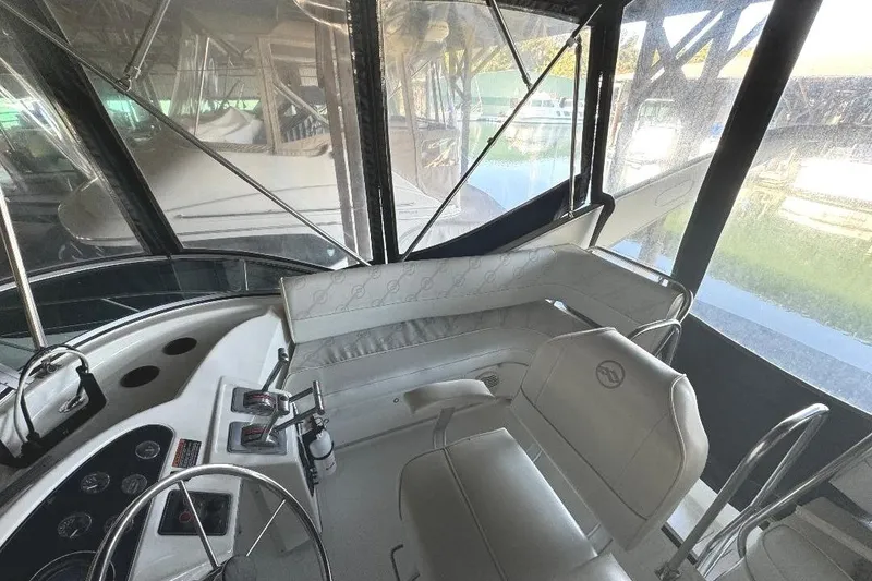 Slide: The Image of 1999 Bayliner 3388 Command Bridge Motoryacht interior with steering wheel and seating area. - 22
