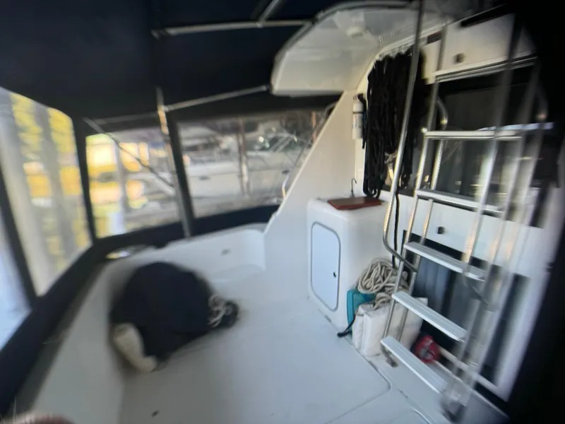 Slide: The Image of 1999 Bayliner 3388 Command Bridge Motoryacht interior with seating and ladder. - 24