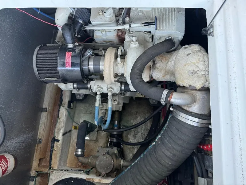 Slide: The Image of Engine compartment of a 1999 Bayliner 3388 Command Bridge Motoryacht, showing mechanical components. - 25