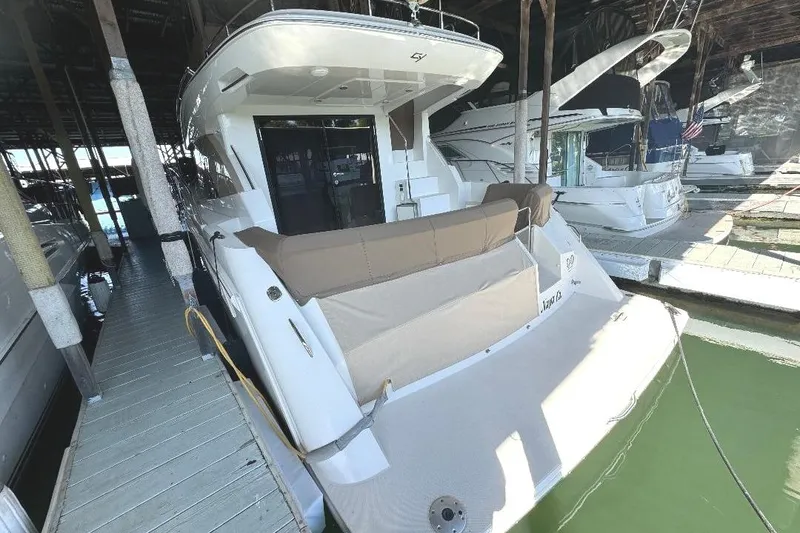 Slide: The Image of 1999 Bayliner 3388 Command Bridge Motoryacht docked in a marina. - 28