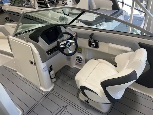 Slide: The Image of 2025 Chaparral 21 SSi boat interior with steering wheel and captain's chair. - 4