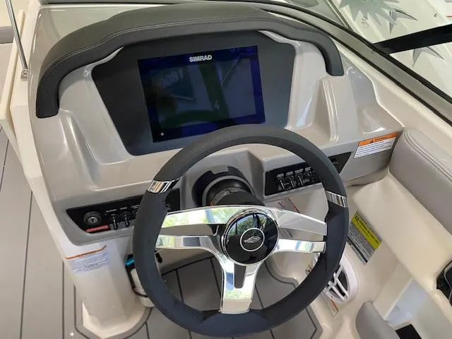Slide: The Image of 2025 Chaparral 21 SSi boat interior with steering wheel and captain's chair. - 5
