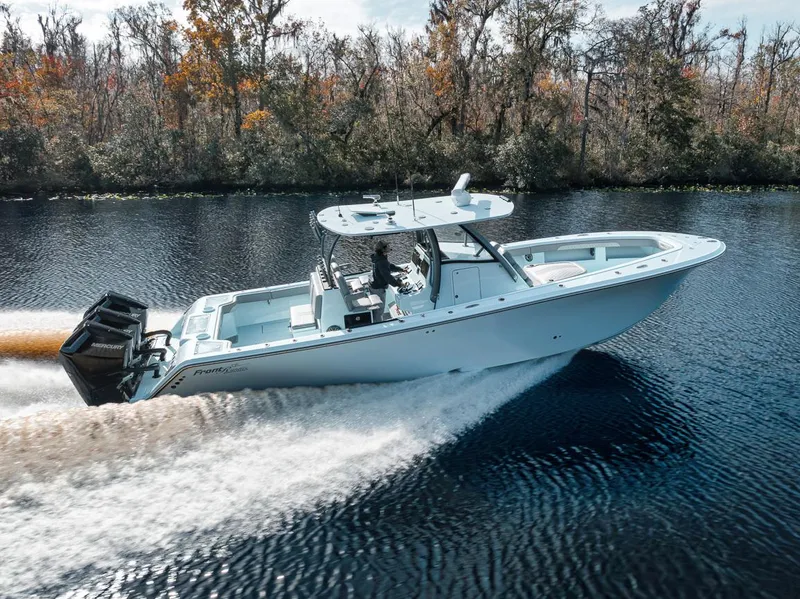 The Image of 2024 Front Runner 36 Center Console boat cruising on a scenic river. - 0