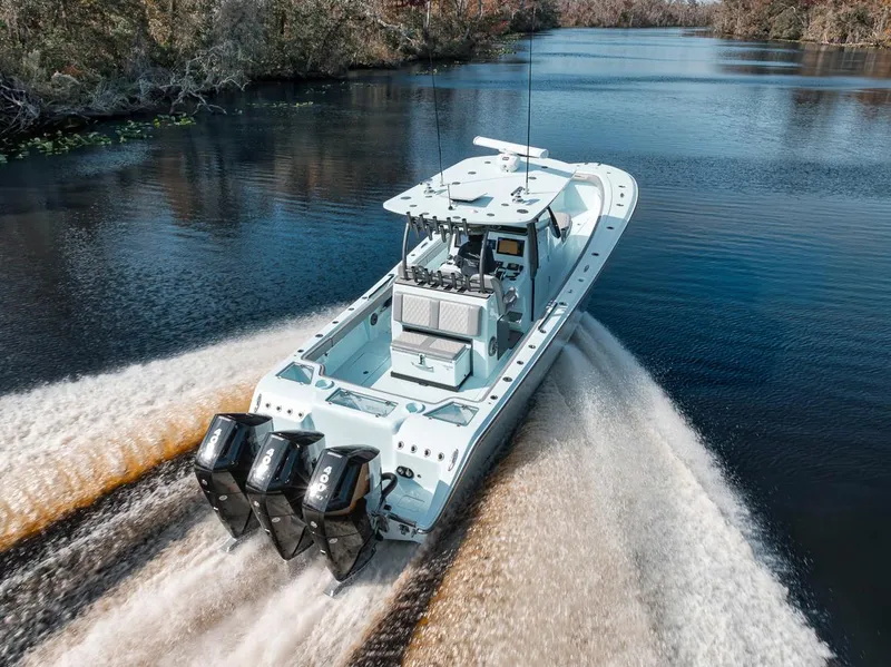 Slide: The Image of 2024 Front Runner 36 Center Console boat cruising on a scenic river. - 17