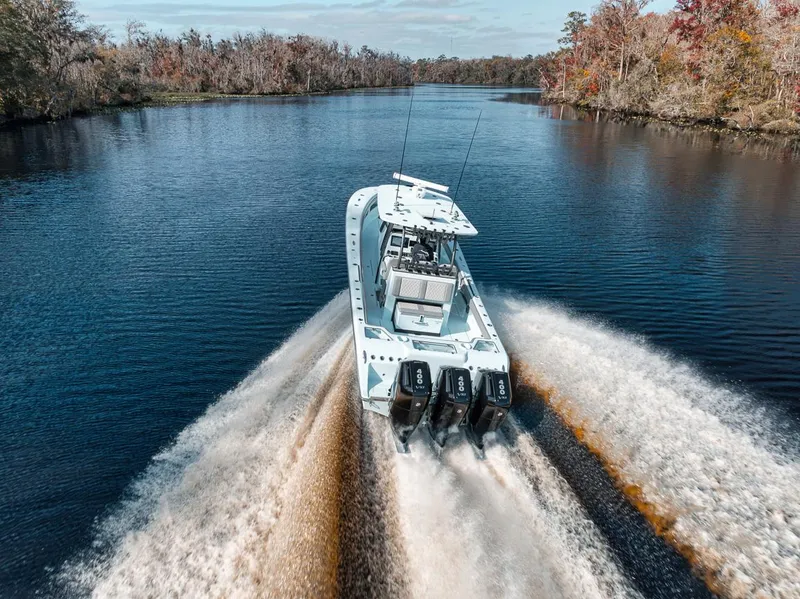 Slide: The Image of 2024 Front Runner 36 Center Console boat cruising on a scenic river. - 19