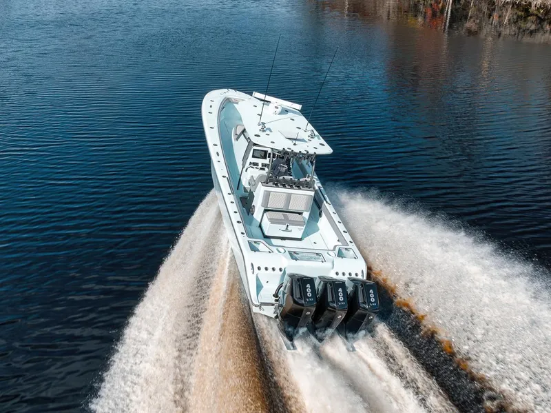 Slide: The Image of 2024 Front Runner 36 Center Console boat speeding on water, showcasing powerful engines. - 20