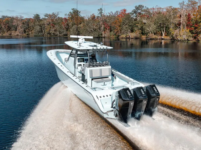 Slide: The Image of 2024 Front Runner 36 Center Console boat cruising on a scenic lake. - 21