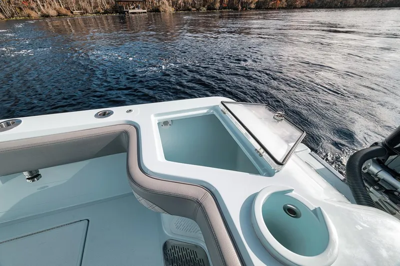 Slide: The Image of 2024 Front Runner 36 Center Console boat with open storage compartment on calm water. - 22