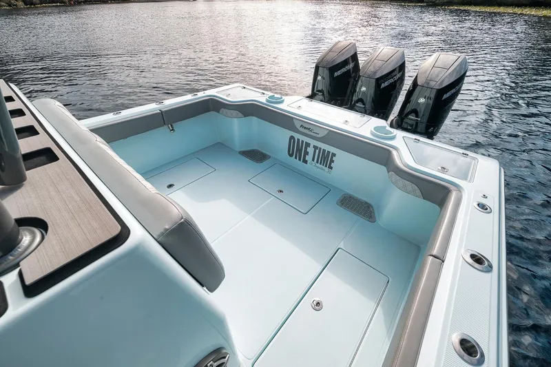 Slide: The Image of 2024 Front Runner 36 Center Console boat with triple engines on a calm lake. - 28