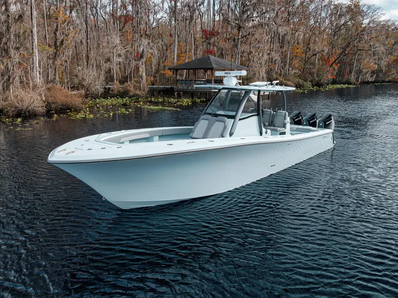 Slide: The Image of 2024 Front Runner 36 Center Console boat on a serene lake. - 3