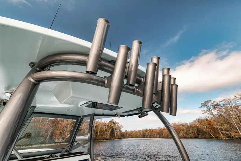 Slide: The Image of 2024 Front Runner 36 Center Console boat with rod holders on a scenic river. - 31