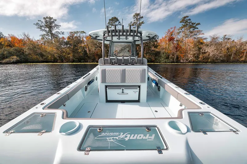 Slide: The Image of 2024 Front Runner 36 Center Console boat on a serene lake with autumn trees. - 32