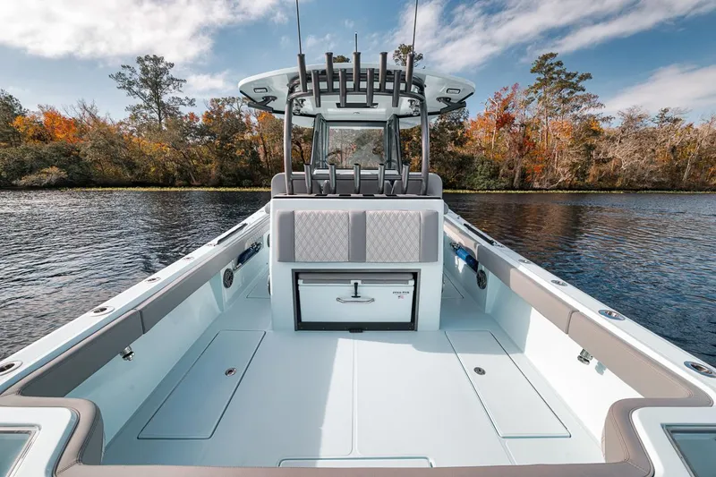 Slide: The Image of 2024 Front Runner 36 Center Console boat on a serene lake with autumn trees. - 33