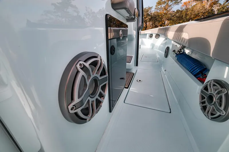 Slide: The Image of 2024 Front Runner 36 Center Console boat interior with speakers and storage compartments. - 37