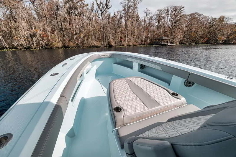 Slide: The Image of 2024 Front Runner 36 Center Console boat on a serene lake with forested shoreline. - 46