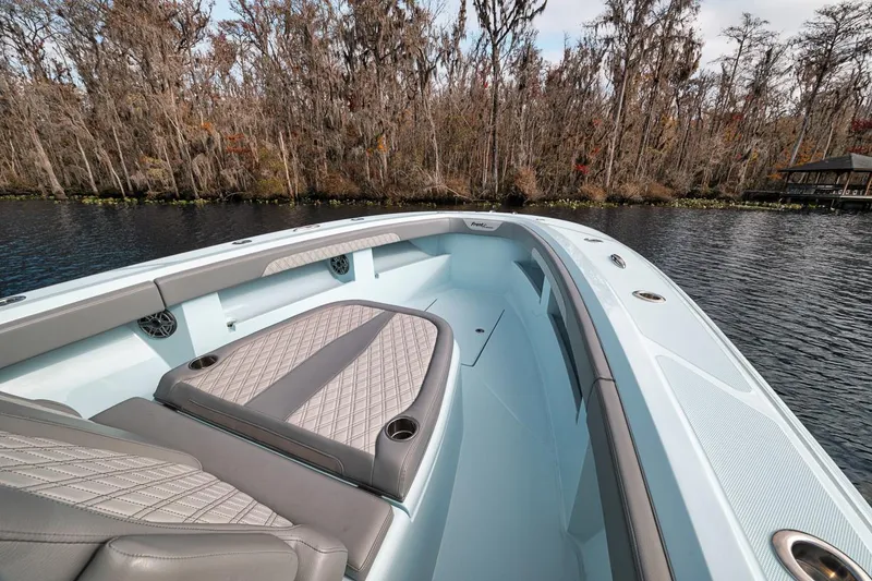 Slide: The Image of 2024 Front Runner 36 Center Console boat on a serene lake with forest backdrop. - 47