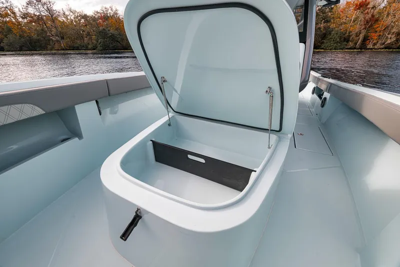 Slide: The Image of 2024 Front Runner 36 Center Console boat with open storage compartment on deck. - 49