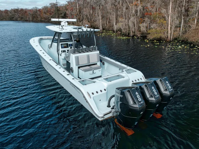 Slide: The Image of 2024 Front Runner 36 Center Console boat with triple 400 engines on a serene lake. - 5