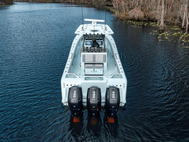 Slide: The Image of 2024 Front Runner 36 Center Console boat with quad 400 engines on a serene lake. - 6