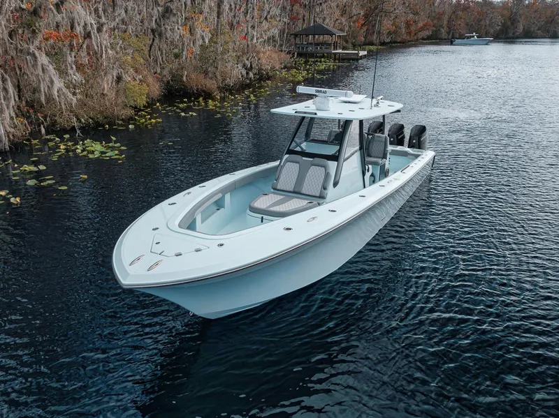 Slide: The Image of 2024 Front Runner 36 Center Console boat on a serene river. - 9