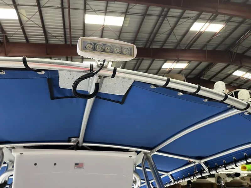 Slide: The Image of 2001 Pro-Line 25 Sport boat with blue canopy and mounted LED light. - 11